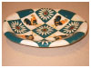 A Bali stoneware cockerel and daisy oval dish, decorated with cockerels and daisies in diamond shapes - second view.